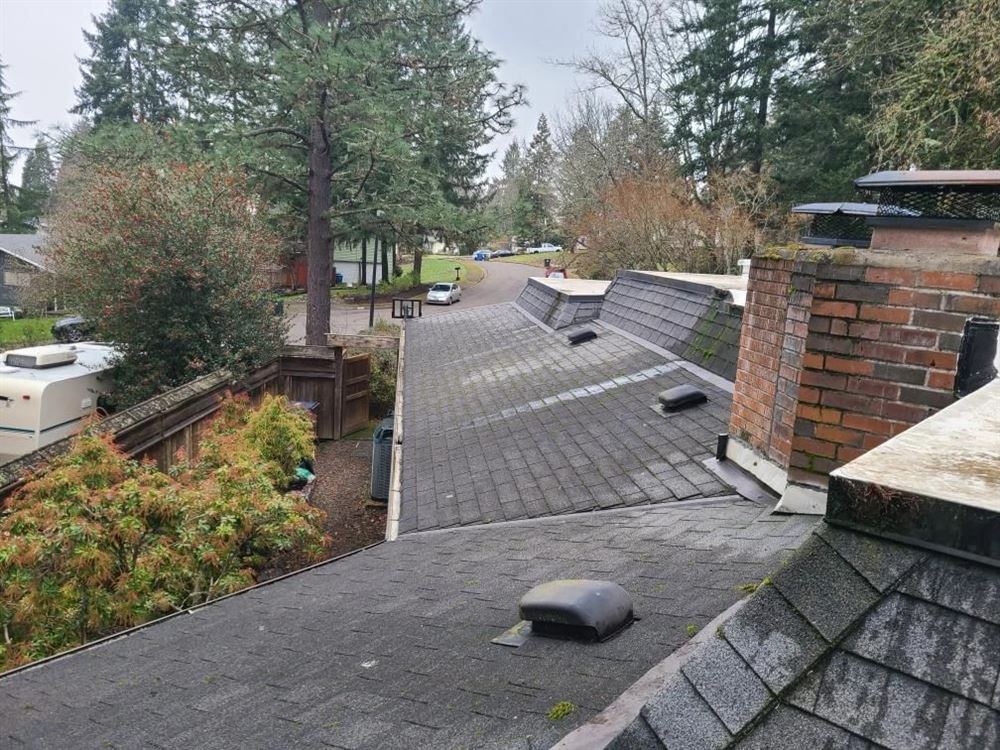 A cleared roofline and open gutter run on a home in Eugene, Oregon